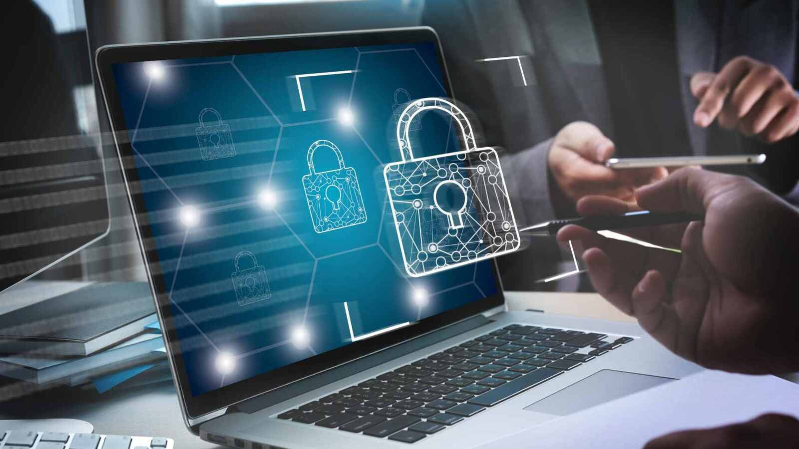 Lock popping out of laptop to signify cybersecurity
